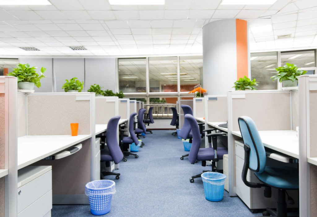 An office space with chairs and cubicles.